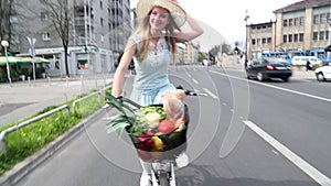 Pretty blonde girl riding bike on the road