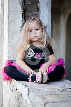 Pretty blonde girl sitting on ruins