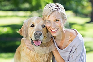 Pretty blonde with her dog in the park