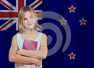 Pretty blonde preteen girl student portrait on New Zealand flag background. Education and school in New Zealand concept