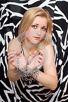 Pretty blonde stretches out her hands in chains