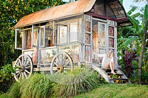 Pretty blonde woman and antique gypsy caravan 6