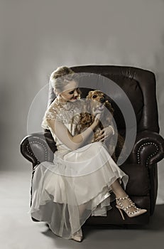 Pretty blonde woman with dog on her lap