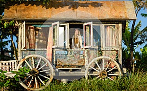 Pretty blonde woman and antique gypsy caravan 4