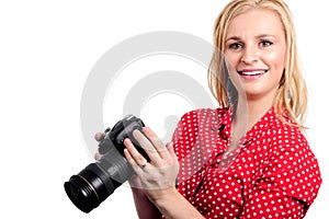 Pretty blonde woman photographer with her camera, on white