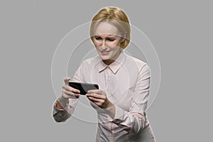 Pretty blonde woman playing online game.