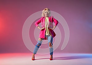 Blonde model posing over pink red background