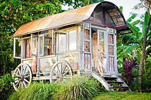 Pretty blonde woman and antique gypsy caravan 8