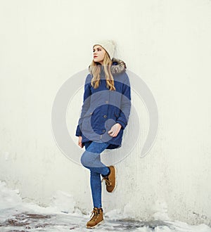 Pretty blonde woman wearing a jacket and hat