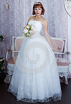 Pretty bride posing in wedding dress photo