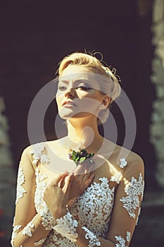 Pretty bride in wedding dress with flower