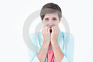 Pretty brunette biting nails with anxiety