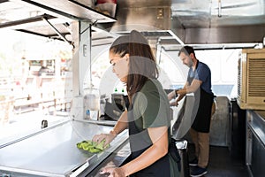 Woman cleaning a food truck