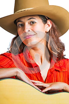 Pretty brunette cowgirl with a guitar