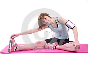 Pretty brunette doing the hamstring stretch on exercise mat