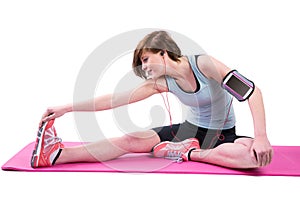 Pretty brunette doing the hamstring stretch on exercise mat