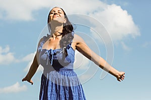 Pretty brunette in dress enjoying the sunshine