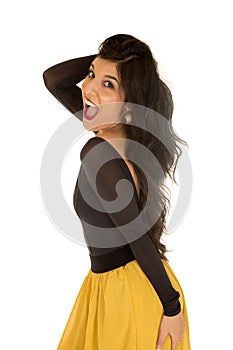 Pretty brunette female model standing wearing yellow skirt