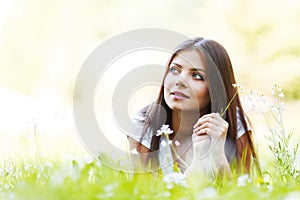 Pretty brunette girl laying on grass