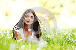 Pretty brunette girl laying on grass