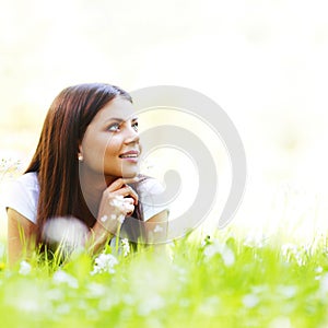 Pretty brunette girl laying on grass