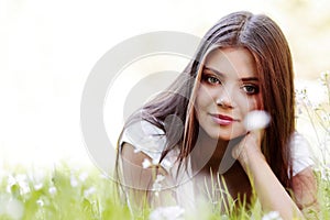 Pretty brunette girl laying on grass