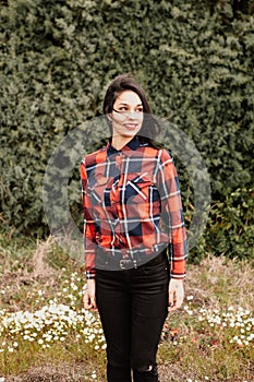 Pretty brunette girl with red plaid shirt