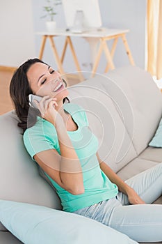 Pretty brunette laughing on the phone