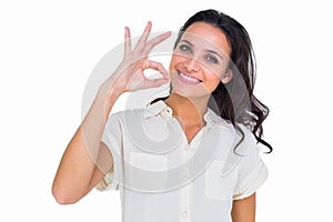 Pretty brunette making ok sign photo