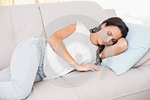 Pretty brunette napping on couch
