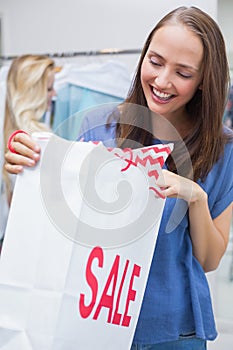 Pretty brunette opening a discounted bag