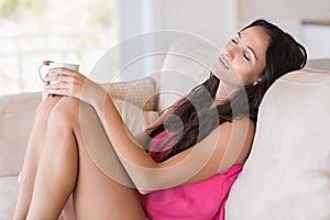 Pretty brunette relaxing on the couch