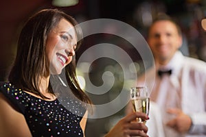 Pretty brunette smiling with champagne