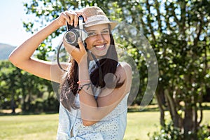 Pretty brunette using retro camera