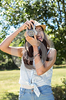 Pretty brunette using retro camera