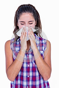 Pretty brunette woman blowing her nose