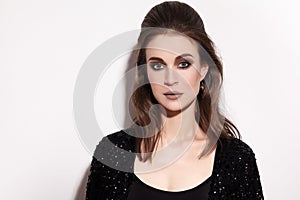Pretty Brunette Woman with Fashion Makeup on White Background. Celebrate Style, Black Sparkle Jacket, Hairstyle