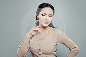 Pretty brunette woman in jewelry gold earrings