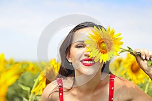 Pretty brunette woman in sunflower field