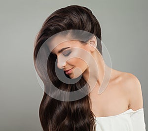 Pretty brunette woman with wavy hairstyle. Beautiful female profile. Hair care concept