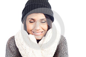 Pretty brunette woman with a woolen hat a sweater and gloves that has cold