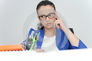Pretty Business woman analyzing investment charts with calculator and laptop