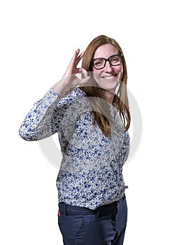 Pretty business woman making ok gesture with glasses