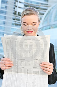 Pretty Business Woman Reading Newspaper