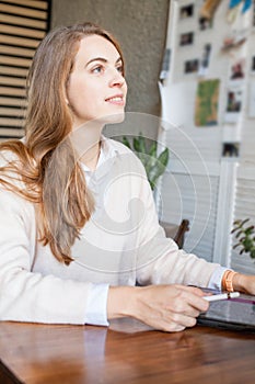 Pretty business woman sitting with laptop gadget and working in office