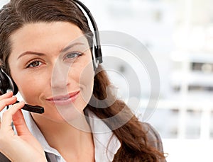 Pretty businesswoman with earpiece smiling