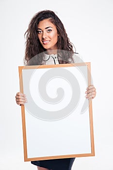 Pretty businesswoman holding blank board