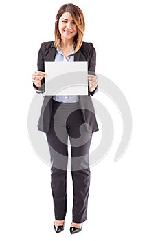 Pretty businesswoman holding up a sign