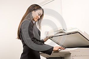 Pretty businesswoman making copies