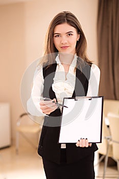 Pretty businesswoman offering to sign a contract